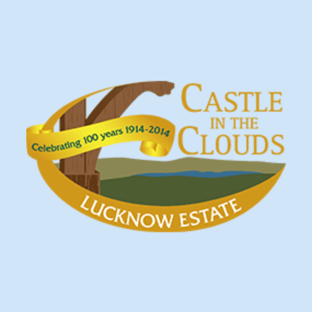 Logo for Castle in the Clouds, Lucknow Estate, featuring a ribbon that reads “Celebrating 100 years 1914-2014” with a stylized landscape and text in gold on a light blue background.